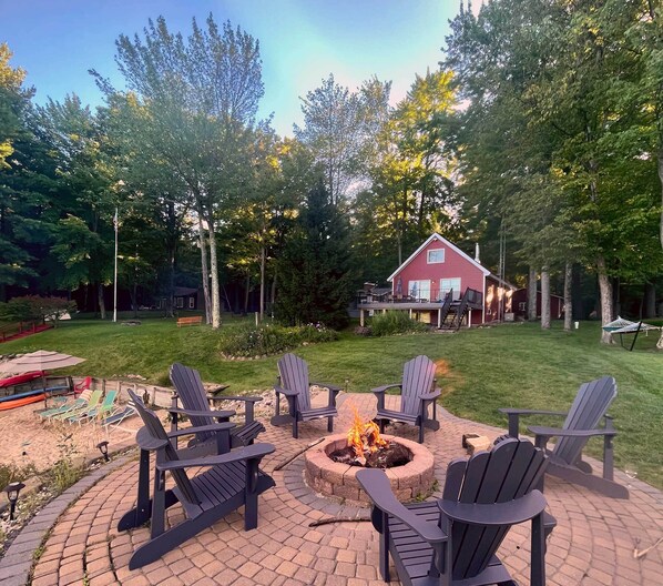 Unique raised stone firepit right at the edge of the lake