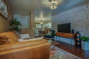 Large screen tv with Roku against a backdrop of designer wallcovering 