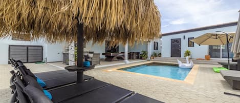 Enjoy your time under this cool patio umbrella made with palm fronds.