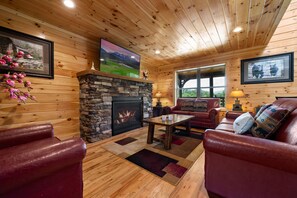 Living room on main level with fireplace and flat screen TV