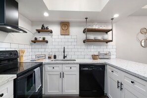 Stunning kitchen with custom shelving. Basics are provided to cook up your favorite meal. Olive oil, salt, pepper, pots, pans, utensils, etc. can be found. If you have a question about any of our appliance, just ask!