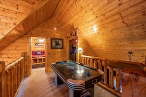 Game Loft: Challenge friends to air hockey while enjoying rustic charm and breathtaking views!