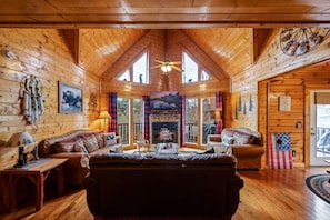 Living Room: Sunlit sanctuary with soaring ceilings, rustic charm, and stunning views—your retreat awaits!