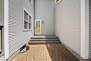 Side entrance, in between front porch & garage.