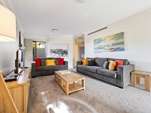 Gather in the downstairs living room with plenty of space for everyone to watch some TV.