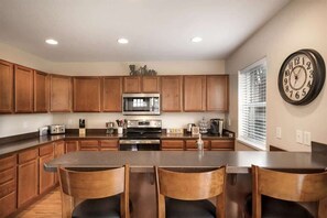 full kitchen with bar stools