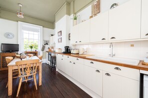 Fully equipped French-style kitchen overlooking the square and courtyard...