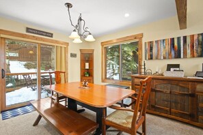 The charming dining area seats six and is conveniently situated between the living room and kitchen areas. Surrounded by windows, you can take in the natural light from any seat at the table.