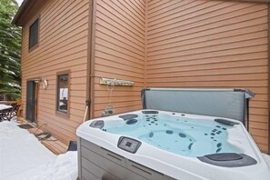 A spacious outdoor deck accessed off of the dining area features a propane BBQ grill, patio seating for six and a private hot tub where you can fire up the grill, take in the fresh mountain air and soak your cares away.