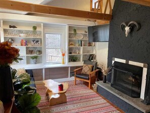 Cozy living room with wood burning fireplace