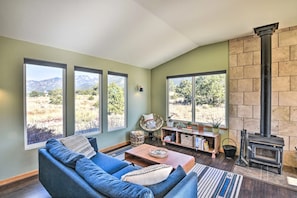 Wood-burning fireplace, games, books, and ample seating for entertaining.