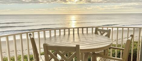 Private balcony with table and chairs, overlooking the Atlantic Ocean.  