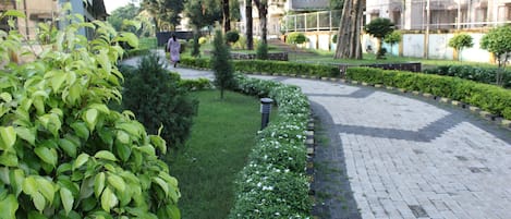 A green verge adjacent to 'Happy Home'.