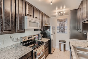 Fully equipped kitchen w/dishwasher, disposal, & cooking & serving dishes.