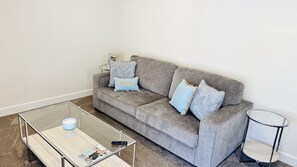 Queen size sofa sleeper w/crisp sheets and ample blankets & pillows.