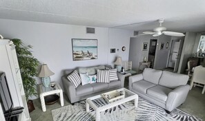 Living Room overlooking community pool and ocean views from balcony