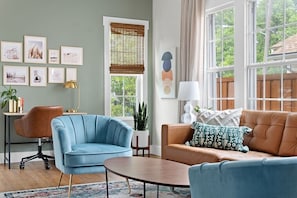 The living room is light-filled and spacious! Relax in this comfortable space and watch your favorite shows on the 65" smartTV that has all of your streaming apps preloaded.