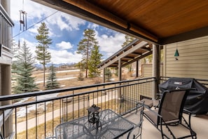 Private balcony offering a gas grill, seating and mountain views.
