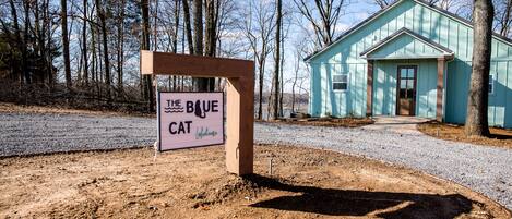 The house has a circle driveway with trailer parking.