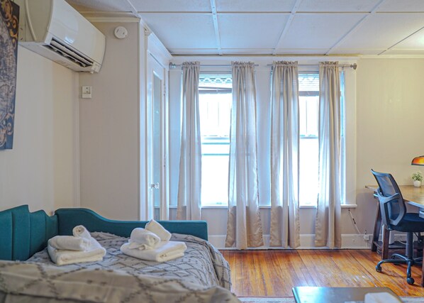 Sleek Stay: Plush Bed & Sunlit Workspace!