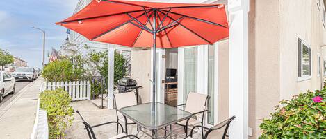This listing pertains to the lower level unit only and includes a private front patio, complete with dining table, umbrella, and propane grill.