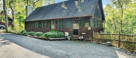 Front of cabin, enclosed front porch and parking area