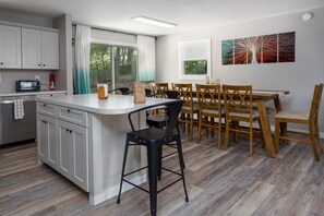 Island seating for 4 and open floor plan into dining area.