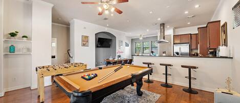 Full-size pool table and foosball table included.