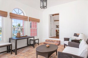 The main entrance welcomes with a quaint sun room foyer with seating and views overlooking Mangrove Bay.