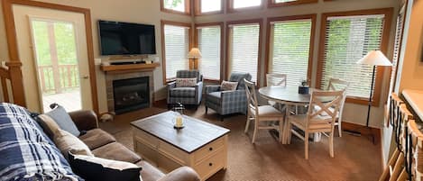 Plenty of seating for your whole group - This upstairs den with a fireplace leads right out to the Boyneland run off the deck door.