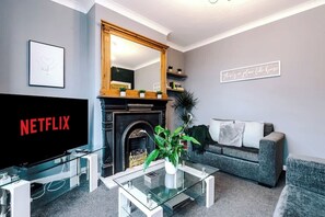 Living Space with Smart TV. A double sofa bed that can be set up as an additional sleeping area upon request.
