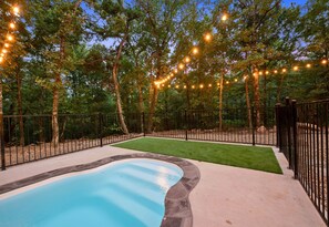 Unwind in this inviting corner, where the gentle ambiance of twinkling lights complements the serene pool by your side. Ideal for those tranquil evenings!