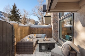 Private outdoor patio with sectional and gas fIre-pit