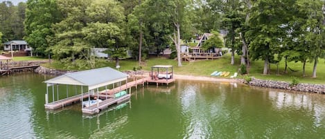 Ariel view of property including dock, overwater lounge, yard, porch and home