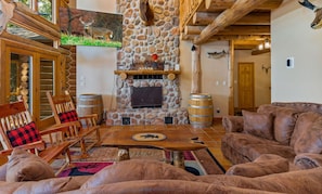 Spacious open living room with electric fireplace, smart TV, and spectacular views of the lake