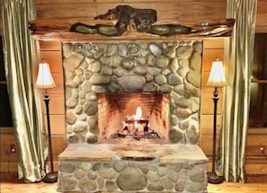 Wood burning fire place with hand carved bear mantel