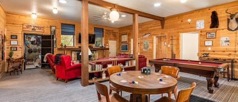 Living room with game table, pool table, toy vault, and living room set that seats 8 comfortably!