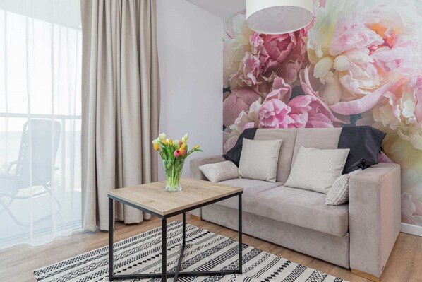The living room features a sleek coffee table and a flat-screen television.