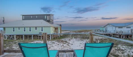 Relax on the wrap around deck, overlooking the beach, during sunrise & sunset!