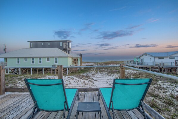 Relax on the wrap around deck, overlooking the beach, during sunrise & sunset!