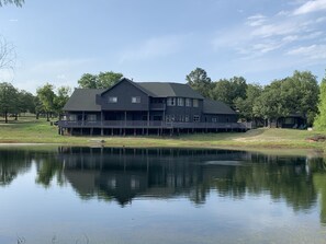 Massive wrap-around back porch overlooking the pond and property