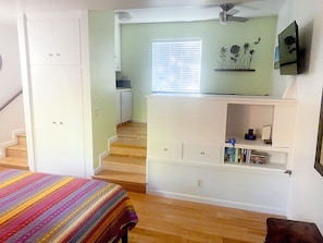 View from entry door, bathroom on left, kitchenette/lounge area on right