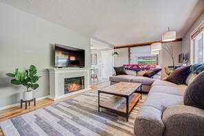Cozy living room with smart TV for streaming, fireplace and record player