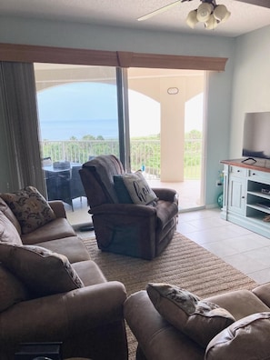 Living Room leads to Balcony over looking the Pool and Ocean
