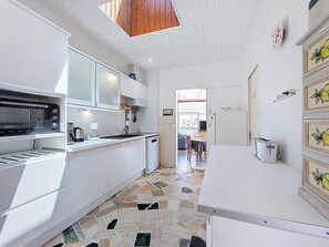 Flooring, Kitchen, Interior Design, Floor, Ceiling, Wood, Countertop, Major Appliance, Kitchen Appliance, Lighting