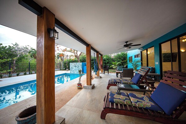 Beautiful patio, pool, and loungers for days of relaxing