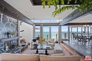 Living room and dining area with full ocean views.