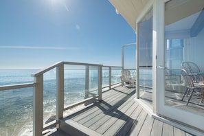 Lower deck spans entire beach front w full ocean views.