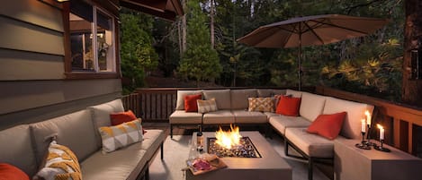 Enjoy the enchanting outdoor forest lounge with firepit and seating for 12