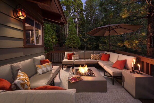 Enjoy the enchanting outdoor forest lounge with firepit and seating for 12